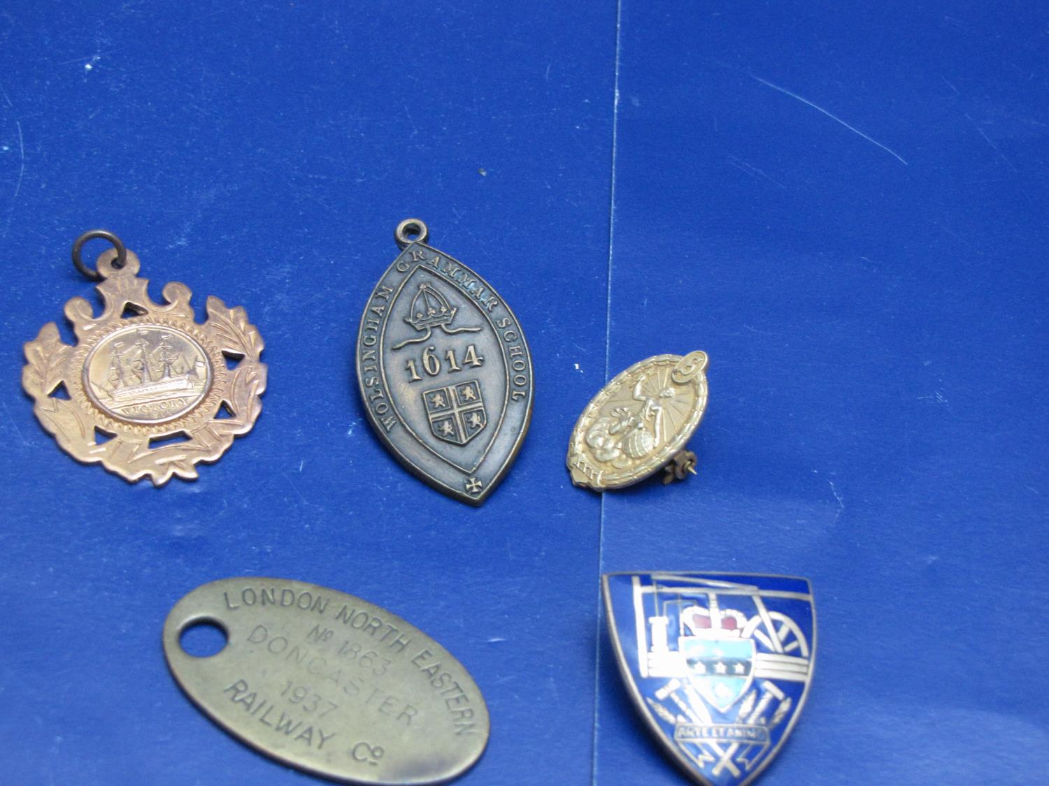 A job lot of collectable badges including silver etc