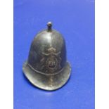 An unusual bronze policeman's helmet in the form of a bell 7cm tall