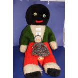 A large vintage plush toy and a topsy tervy doll
