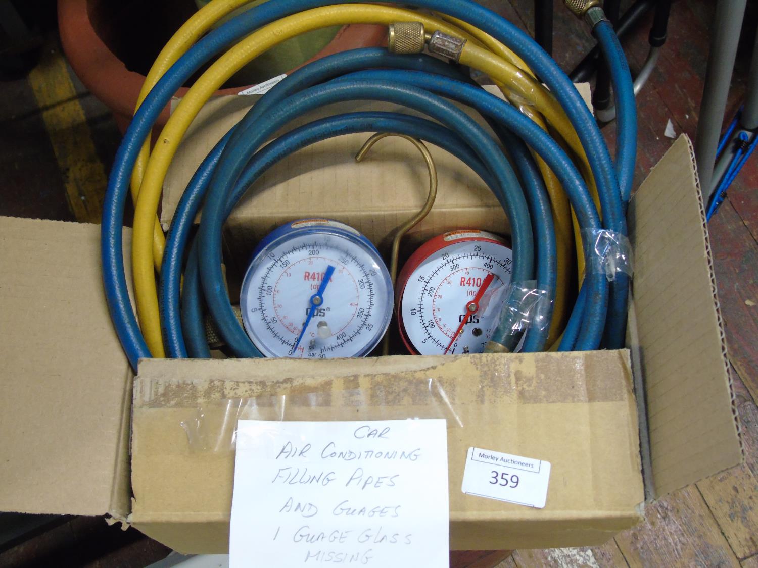 A set of car air conditioning hoses & gauges (one gauge has glass missing)