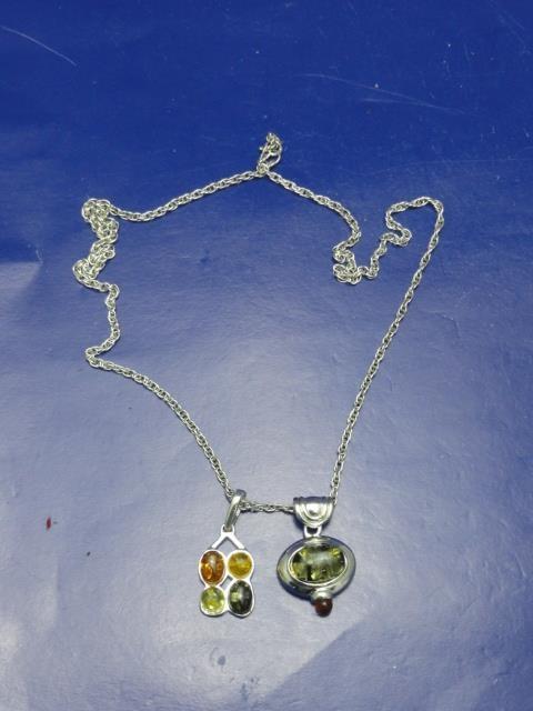 A Sterling silver & amber necklace with two amber pendants