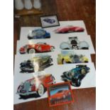 A collection of framed and unframed classic car prints