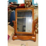 A vintage wooden swivel dressing table mirror