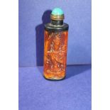 A carved resin Chinese snuff bottle