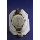A vintage Trebex wrist watch with a 9ct gold body and a 9ct gold front and back bracelet