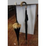 A quality vintage horn handled umbrella with a 9ct gold band, and vintage parasol (tear to parasol