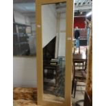 A light wood framed wall mirror unable to post