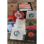 A box of mixed genre 7 inch singles approx 70