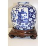 A antique Chinese blue & white porcelain vase with a quality hardwood stand with character marks