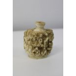 A hand carved Chinese ivory scent bottle with character marks to the base