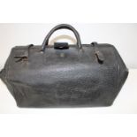 A vintage leather Gladstone style bag.