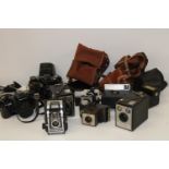A box full of assorted vintage cameras