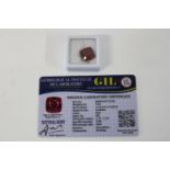 A Ruby gemstone with certificate