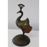 A unusual brass peacock figure