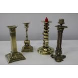 Four assorted antique brass candlesticks