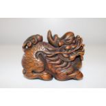 A hand carved Chinese wooden Fou Dog figure 8x7cm