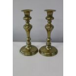 A pair of antique brass candle sticks