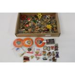 A box full of assorted pin badges etc