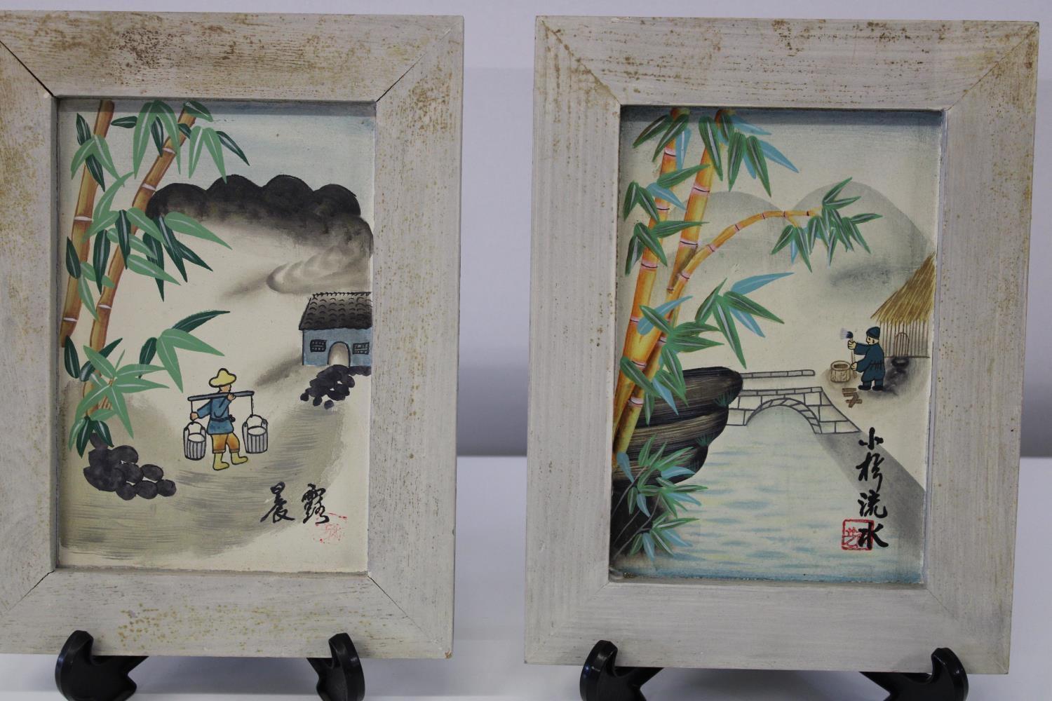 A pair of Japanese framed water colours signed & stamped 38x21cm
