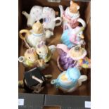 A box full of novelty ceramic teapots