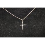 A 9ct white gold & diamond crucifix on a 925 silver chain