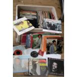 A box of mixed genre 7" singles