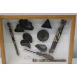 A cased selection of antique cooking utensils