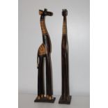 A pair of tall hand carved wooden giraffe's h80cm