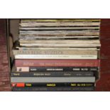 A box of mixed genre LP records