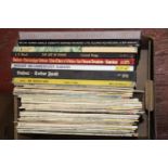 A box of mixed genre LP records