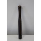 A Victorian truncheon with a ribbed handle & brass tip