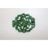 A hand double carved Chinese green jade plaque