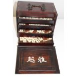 A Chinese Mah Jong set. (pieces made from wood & bone) damage to the front of the box (144 pieces)