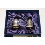 A boxed pair of hallmarked silver candle caps