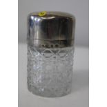 A heavy hallmarked silver topped hobnail cut glass bottle