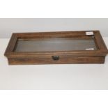 A small wooden glazed display cabinet. 48cm x 22cm