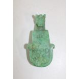 A Chinese green jade belt hook in the form of a dragon