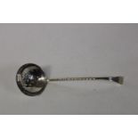 A hallmarked silver straining spoon