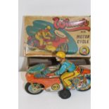 A vintage boxed tin plate friction powered motorcycle
