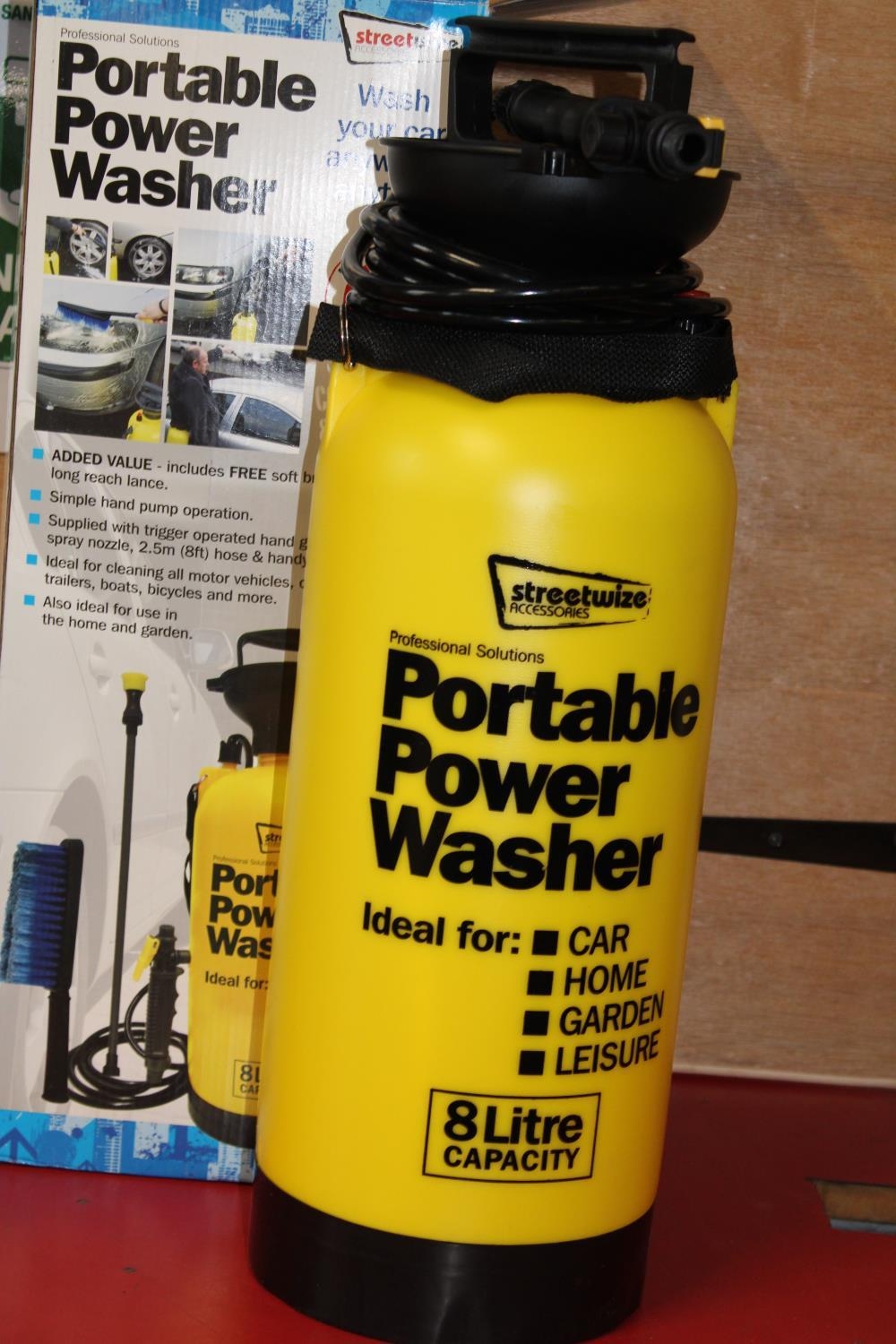 A boxed portable power washer