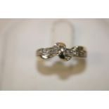 A 9ct white gold diamond crossover style ring size I 1/2