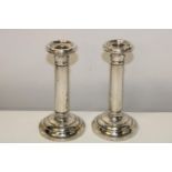 A pair of hallmarked silver candle sticks approx 17cm tall
