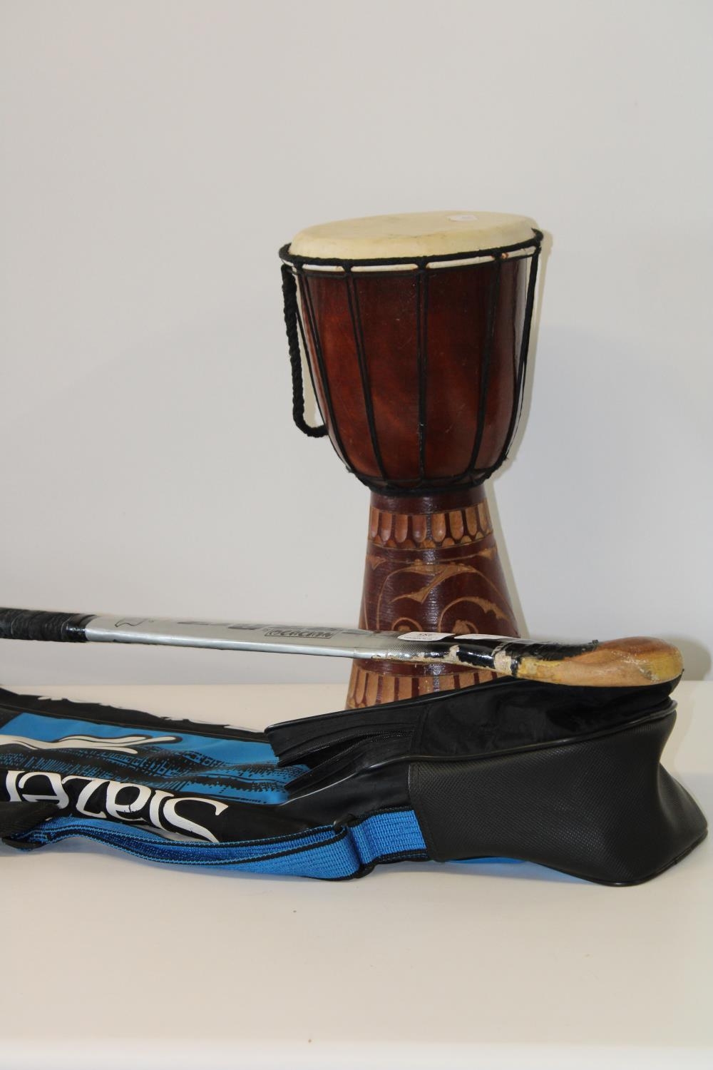 A cased hockey stick and tribal style drum