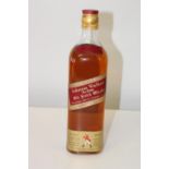 A vintage bottle of Johnnie Walker red label old scotch whiskey 26 2/3 fl ozs 70% proof