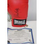 A boxing glove signed by Sir Henry Cooper with COA