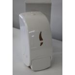 A boxed as new wall mounted soap dispenser