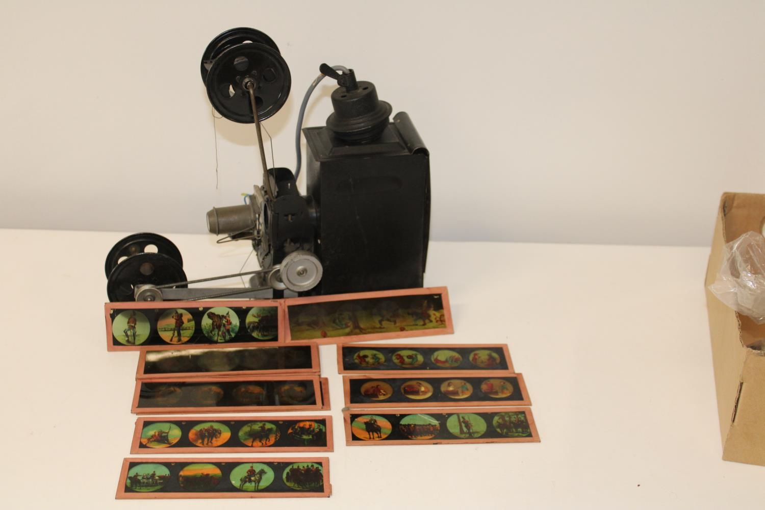 A vintage slide/film projector with some glass slides & films (some military related slides)
