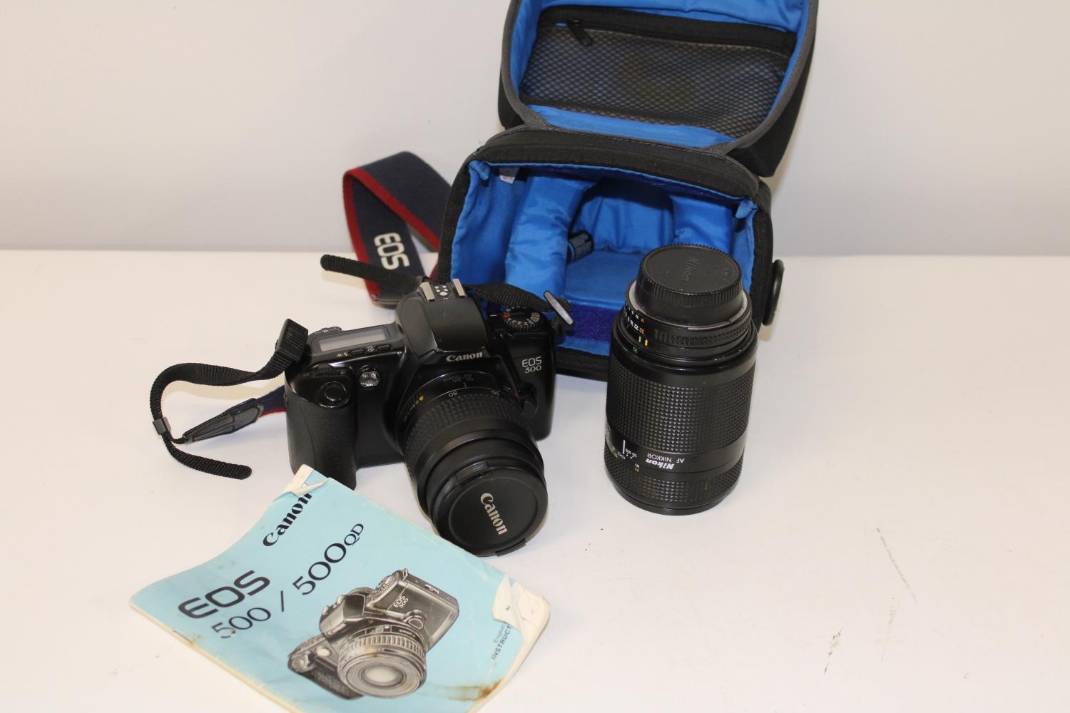 A Canon EOS 500 camera & lens with a Nikon Nikkor camera lens