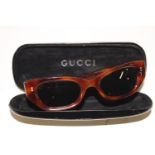 A genuine pair of Gucci tortoise shell style sunglasses with original case