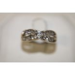 A 9ct white gold 1/4 ct diamond crossover ring size J